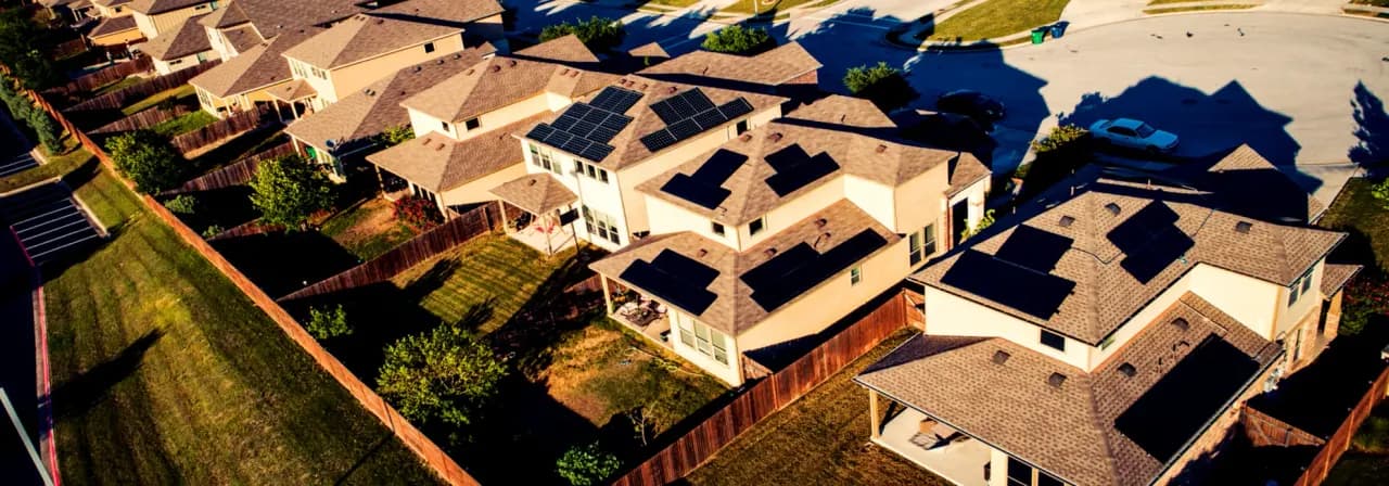 Aerial view of homes with rooftop solar arrays