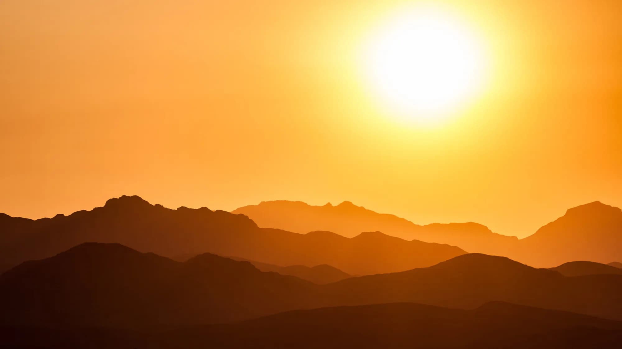 Sunset sky over a suburban rooftop, the illustrative backdrop for Fíor Solar's about page