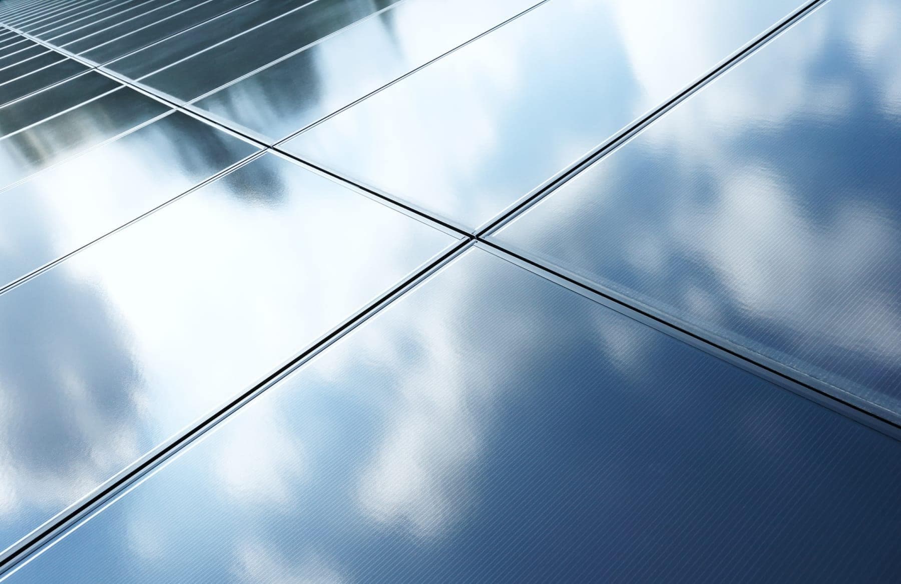 Close detail of solar panels reflecting the sky