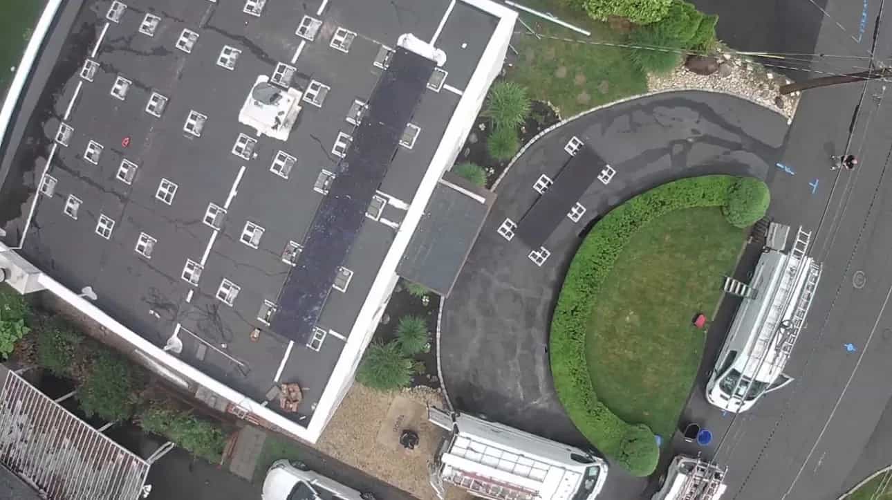 Aerial view of a real Fíor Solar flat-roof installation in Wayne, New Jersey, with the install crew on site